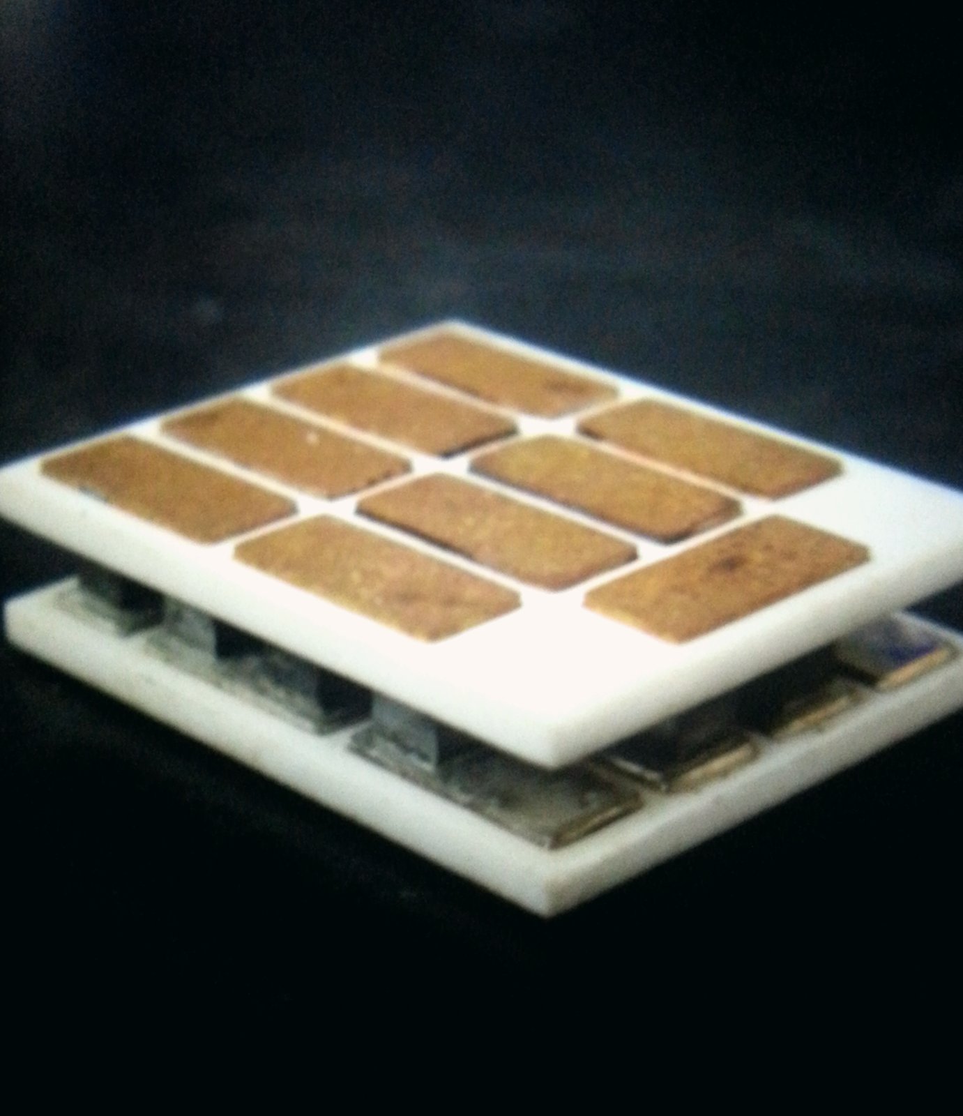 TEG module close-up showing n- and p-type semiconductor legs between ceramic plates