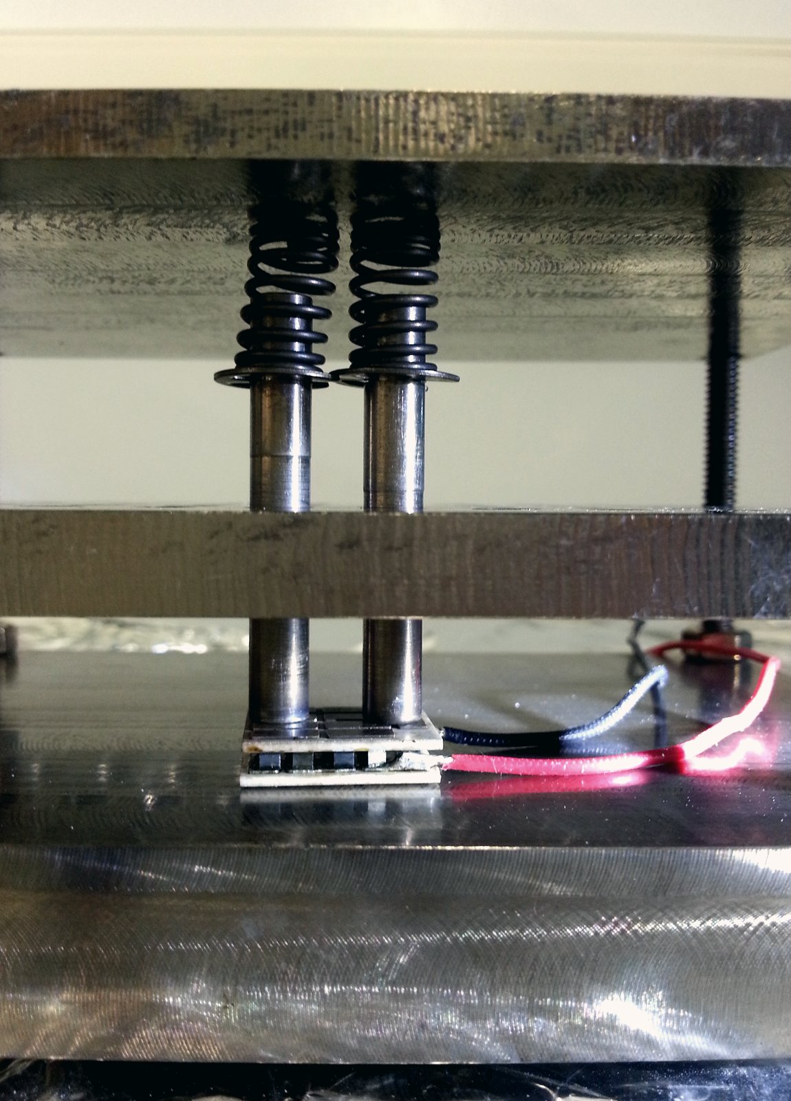 TEG module under spring-loaded press for controlled-contact thermal testing